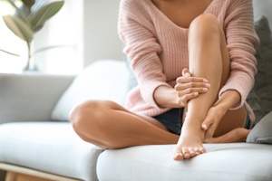 woman with smooth legs sitting on a couch